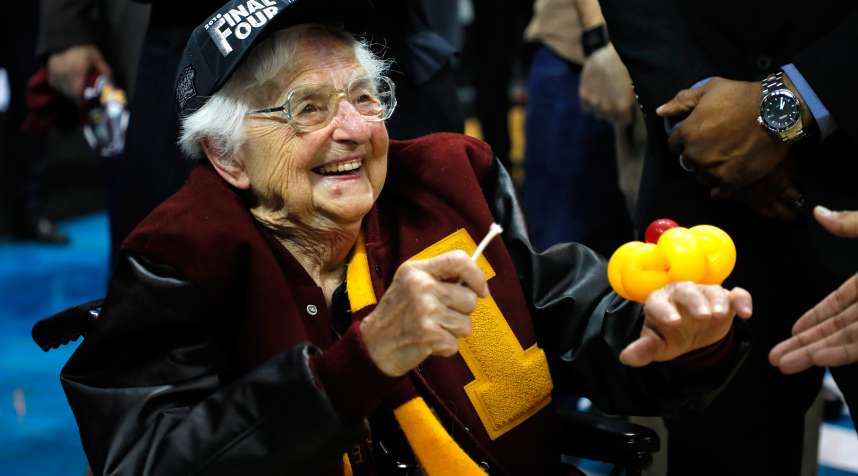 Sister Jean Dolores Schmidt celebrates with the Loyola-Chicago Ramblers after defeating Kansas State during the 2018 NCAA Men's Basketball March Madness Tournament.