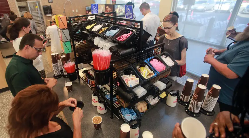 Patrons get frree coffee during the grand opening of the new Wawa on Belvedere Road in West Palm Beach Thursday, June 15, 2017.