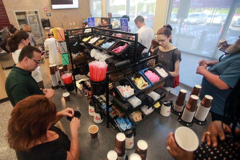 Patrons get frree coffee during the grand opening of the new Wawa on Belvedere Road in West Palm Beach Thursday, June 15, 2017.