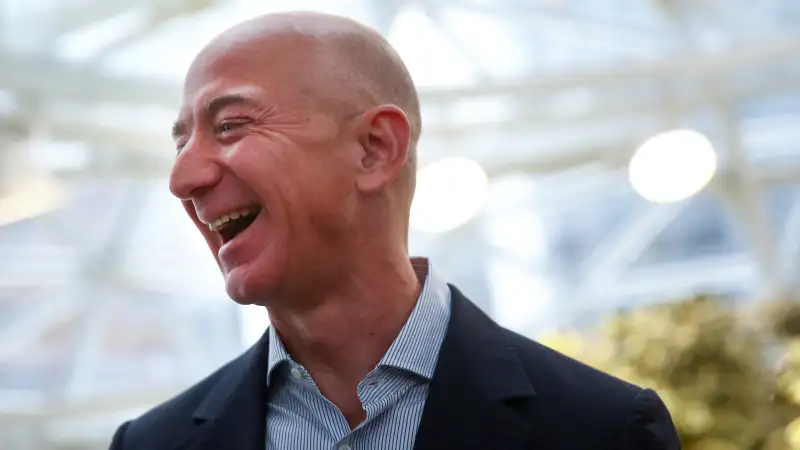 Amazon founder and CEO Jeff Bezos laughs as he talks to the media while touring the new Amazon Spheres during the grand opening in Seattle