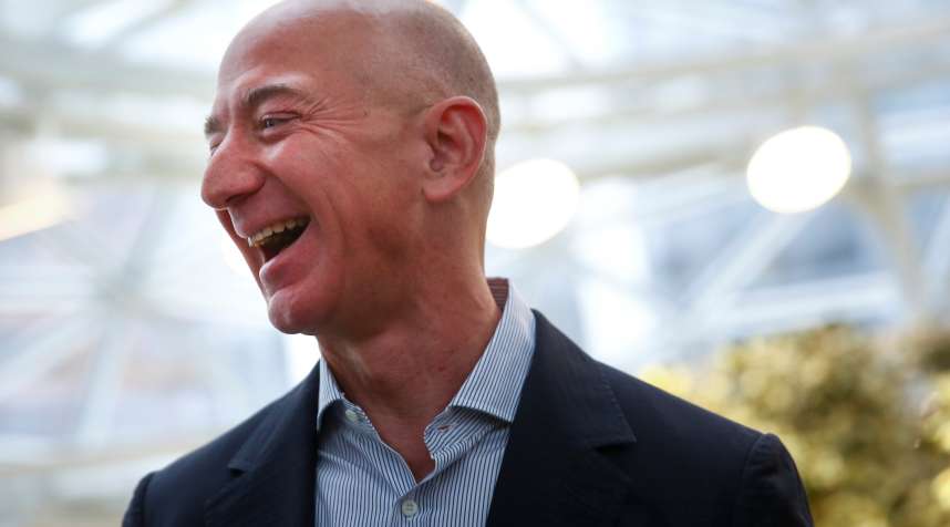 Amazon founder and CEO Jeff Bezos laughs as he talks to the media while touring the new Amazon Spheres during the grand opening at Amazon's Seattle headquarters in Seattle, Washington, January 29, 2018.