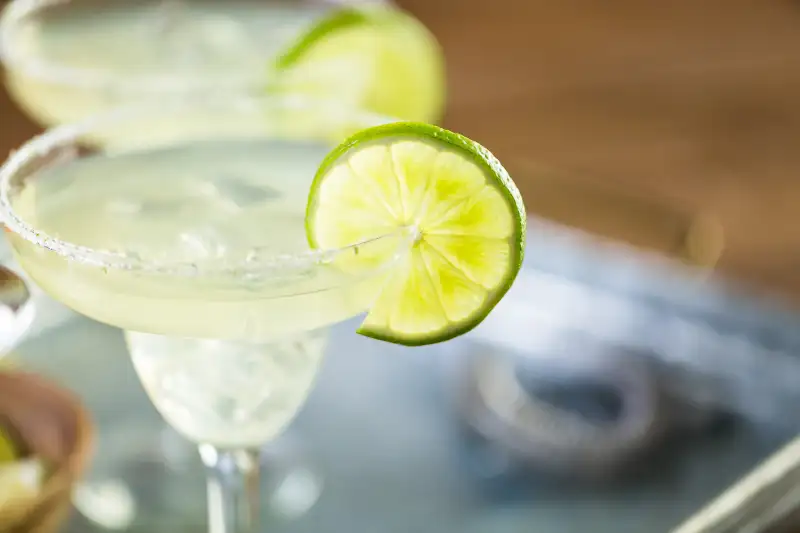 Key lime margarita garnished with fresh lime