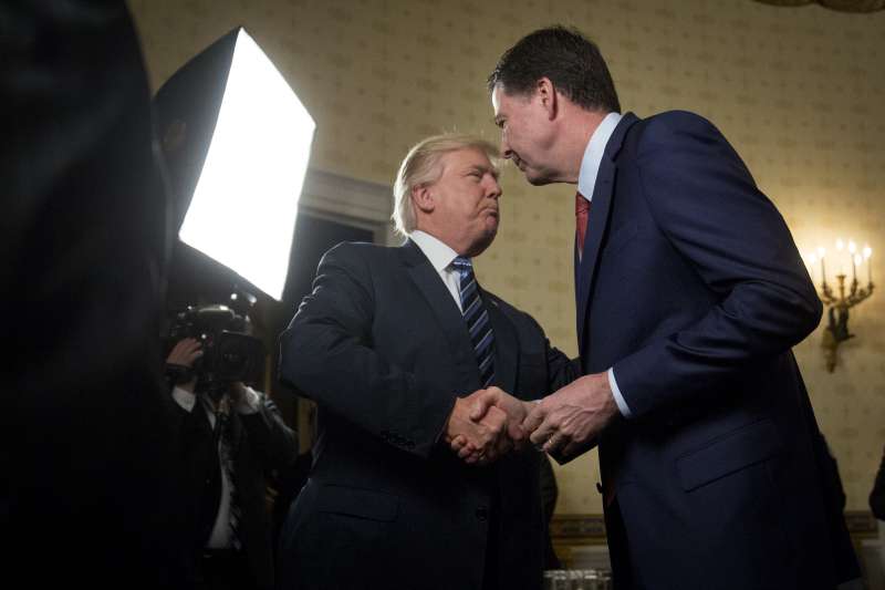 U.S. President Donald Trump, left, shakes hands with James Comey, director of the Federal Bureau of Investigation (FBI), during an Inaugural Law Enforcement Officers and First Responders Reception in the Blue Room of the White House in Washington, D.C., on Jan. 22, 2017.