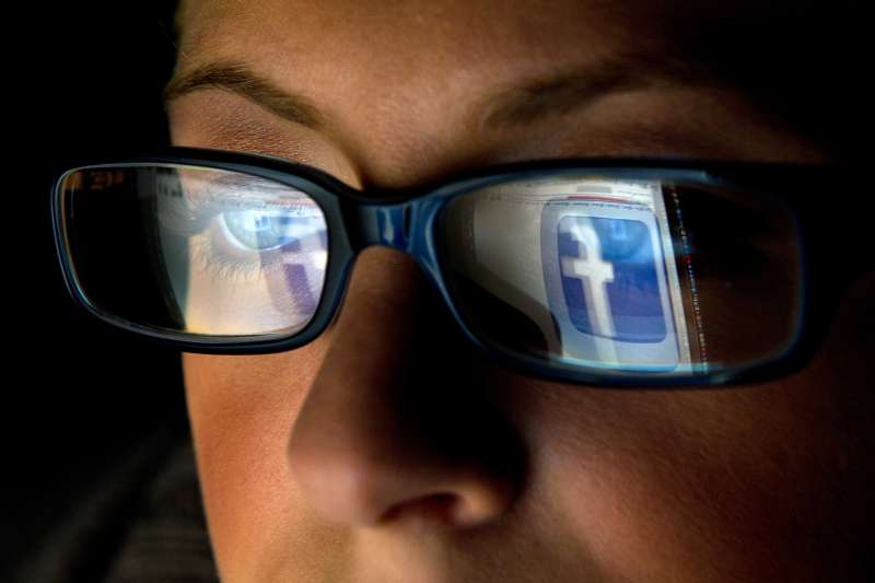 The Facebook Inc. logo is reflected in the eyeglasses of a user in San Francisco, California, U.S., on Wednesday, Dec. 7, 2011.