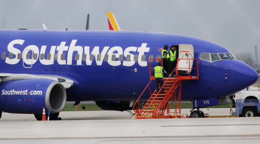 A Southwest Airlines jet sits on the runway at Philadelphia International Airport after it was forced to land with an engine failure, in Philadelphia, Pennsylvania, on April 17, 2018.