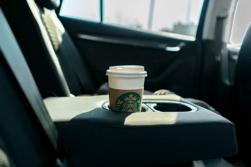 A cup of Starbucks coffee in a car. In 2017, the revenue of