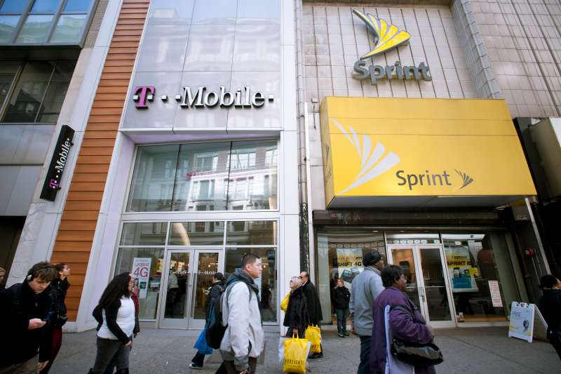 T-Mobile and Sprint Nextel cellular phone stores adjoin each other in Herald Square in New York on Tuesday, March 8, 2011.
