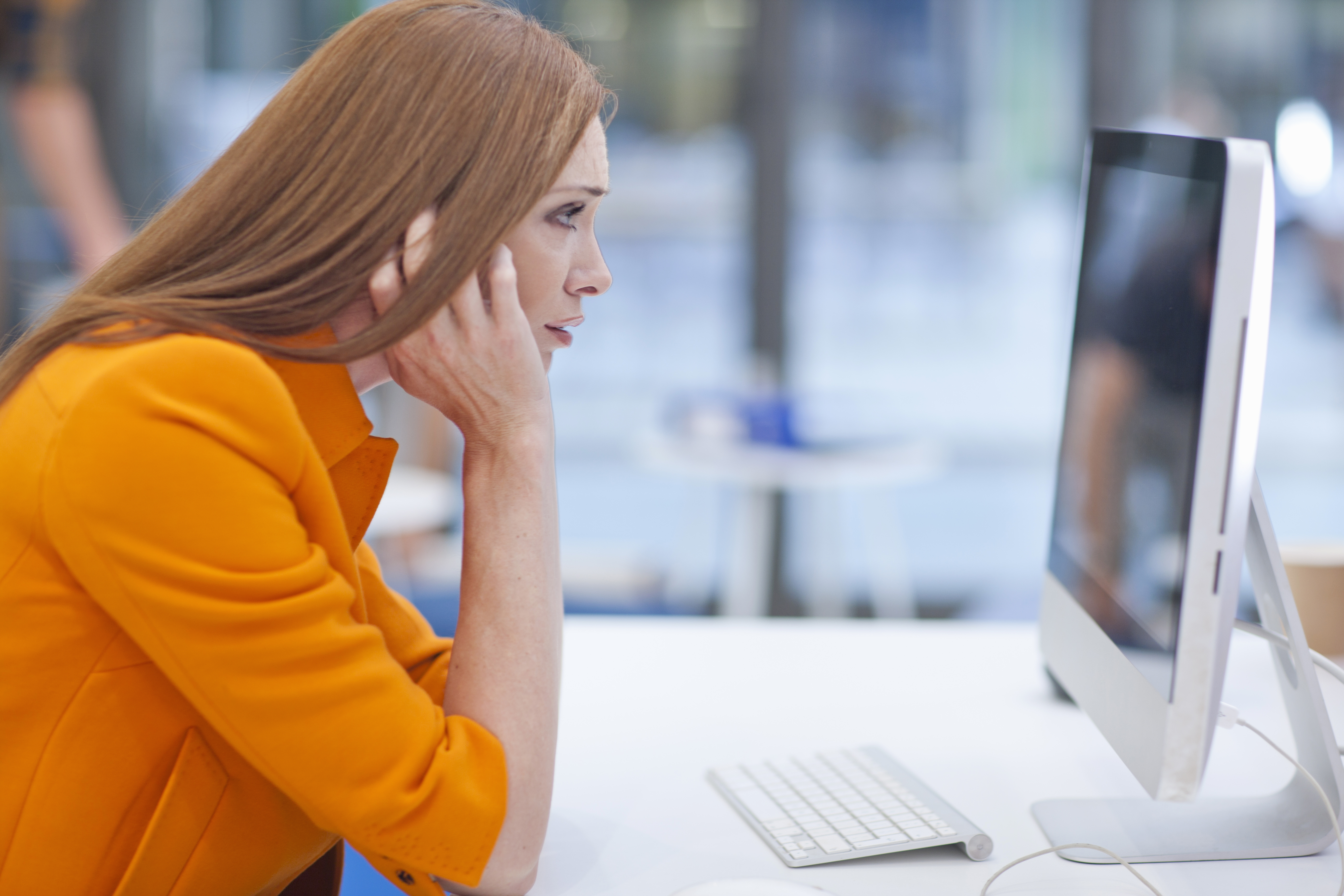 Female office worker staring at computer screen