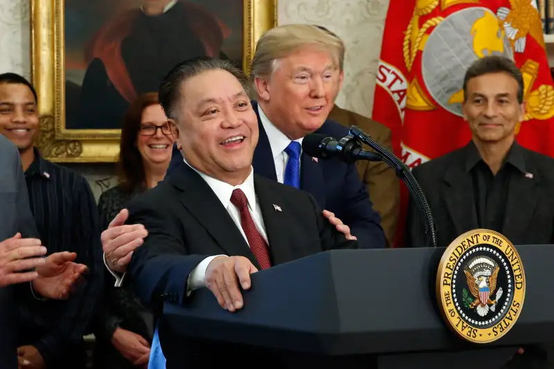 Hock Tan, chief executive officer of Broadcom Ltd., center, speaks as U.S. President Donald Trump, center right, listens during an announcement in the Oval Office of the White House in Washington D.C., on Nov. 2, 2017.