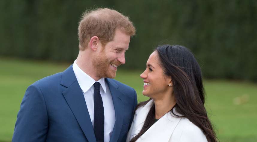 Prince Harry and Meghan Markle, wearing a white belted coat by Canadian brand Line The Label, attend a photocall in the Sunken Gardens at Kensington Palace following the announcement of their engagement on November 27, 2017 in London,  England.