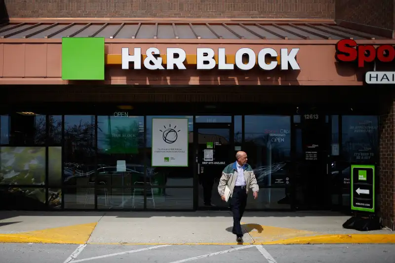 A customer leaves an H&amp;R Block Inc. location in Louisville, Kentucky, U.S., on Thursday, March 23, 2017. H&amp;R Block is one of the largest tax return preparers in the U.S., where it boasts more than 12,000 company-owned and franchised retail locations.