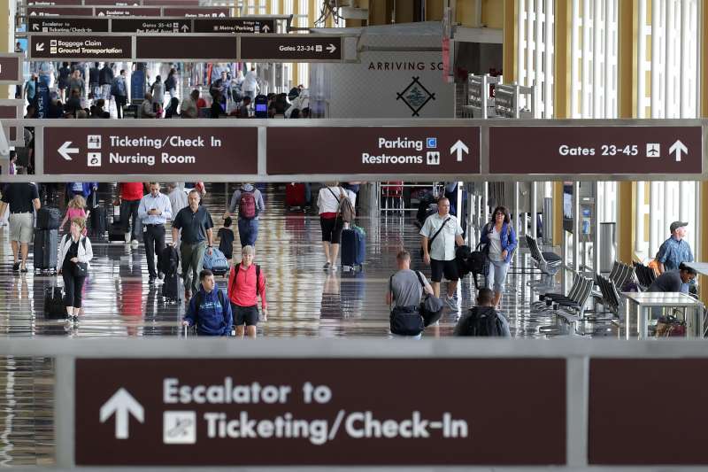 Travelers move through Ronald Reagan National Airport's Terminal B and C September 1, 2017 in Washington, DC.