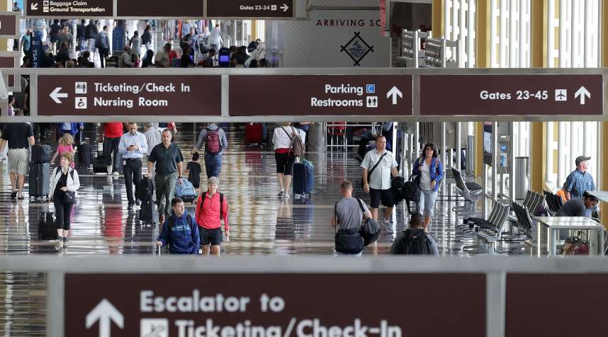 Travelers move through Ronald Reagan National Airport's Terminal B and C September 1, 2017 in Washington, DC.