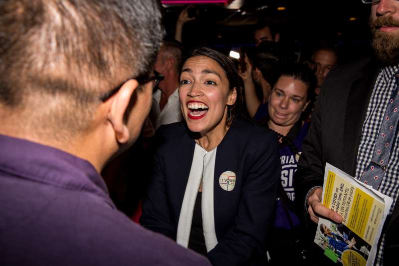 Progressive challenger Alexandria Ocasio-Cortez celebrartes with supporters at a victory party in the Bronx after upsetting incumbent Democratic Representative Joseph Crowley on June 26, 2018 in New York City.  Ocasio-Cortez upset Rep. Joseph Crowley in New York’s 14th Congressional District, which includes parts of the Bronx and Queens.