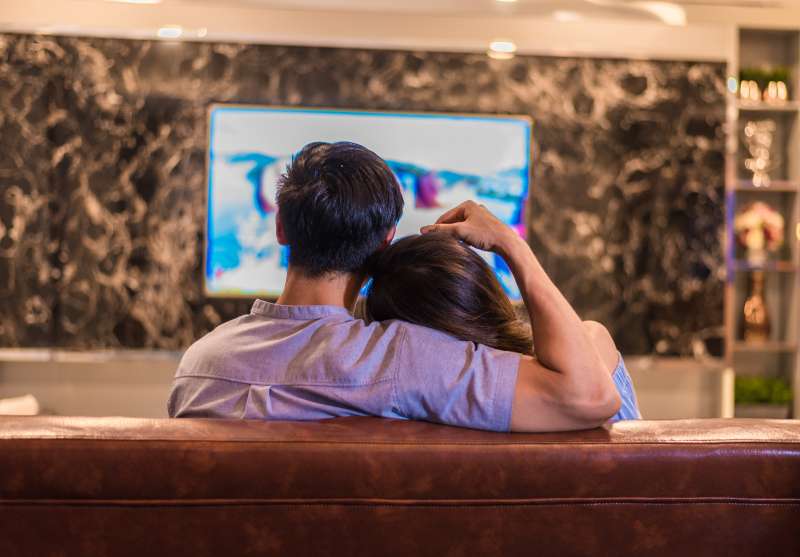 Rear View Of Couple Watching Tv