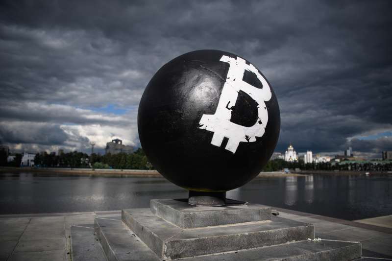 Bitcoin symbol painted on stone sphere monument in Yekaterinburg