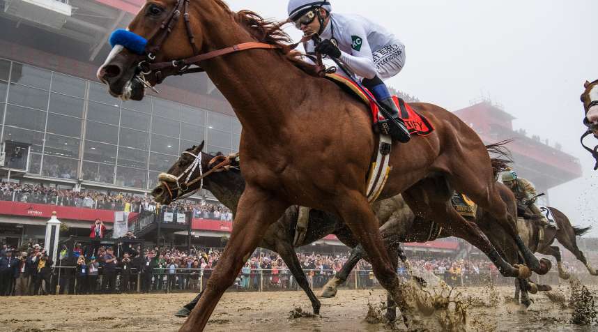 Justify, #7, ridden by jockey Mike Smith, wins the Preakness Stakes at Pimlico Race Course on May 19, 2018 in Baltimore, Maryland.