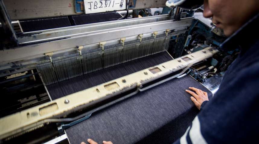 A man works a weaving machine at the Momotaro Jeans  in Kurashiki, Japan.