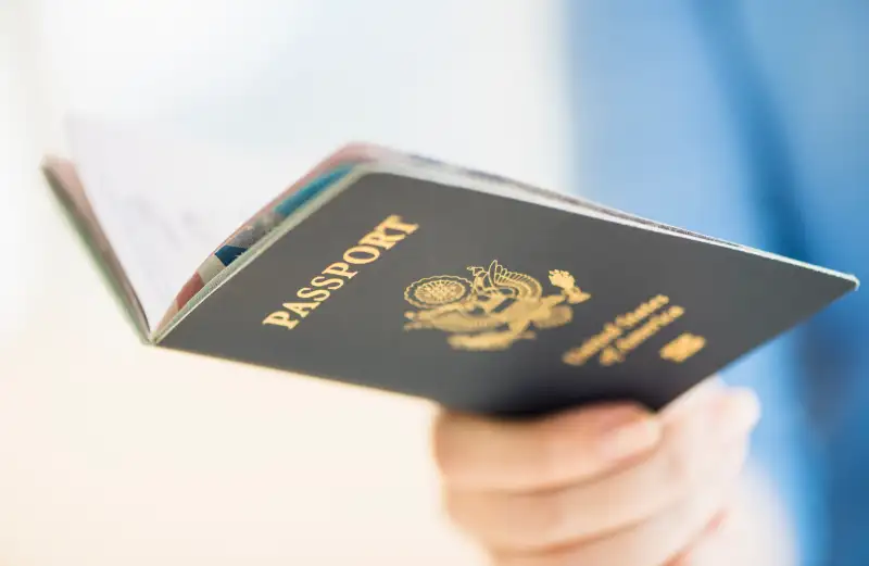 USA, New Jersey, Jersey City, Close up of woman's hand holding open passport