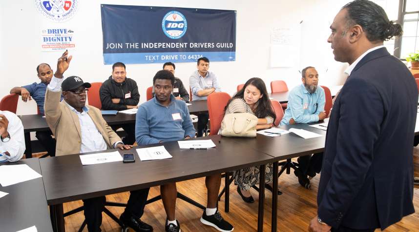 Nichodemus Obih, 65, asks a question at a five-star ratings class at the Independent Drivers Guild in Brooklyn, NY.