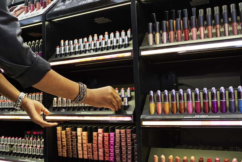 An employee assists a customer with MAC Cosmetics Inc. lipstick at an Ulta Beauty Inc. store in New York, on May 31, 2018.