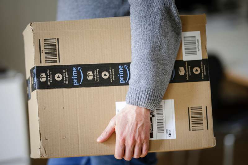 Man holding Amazon Prime package