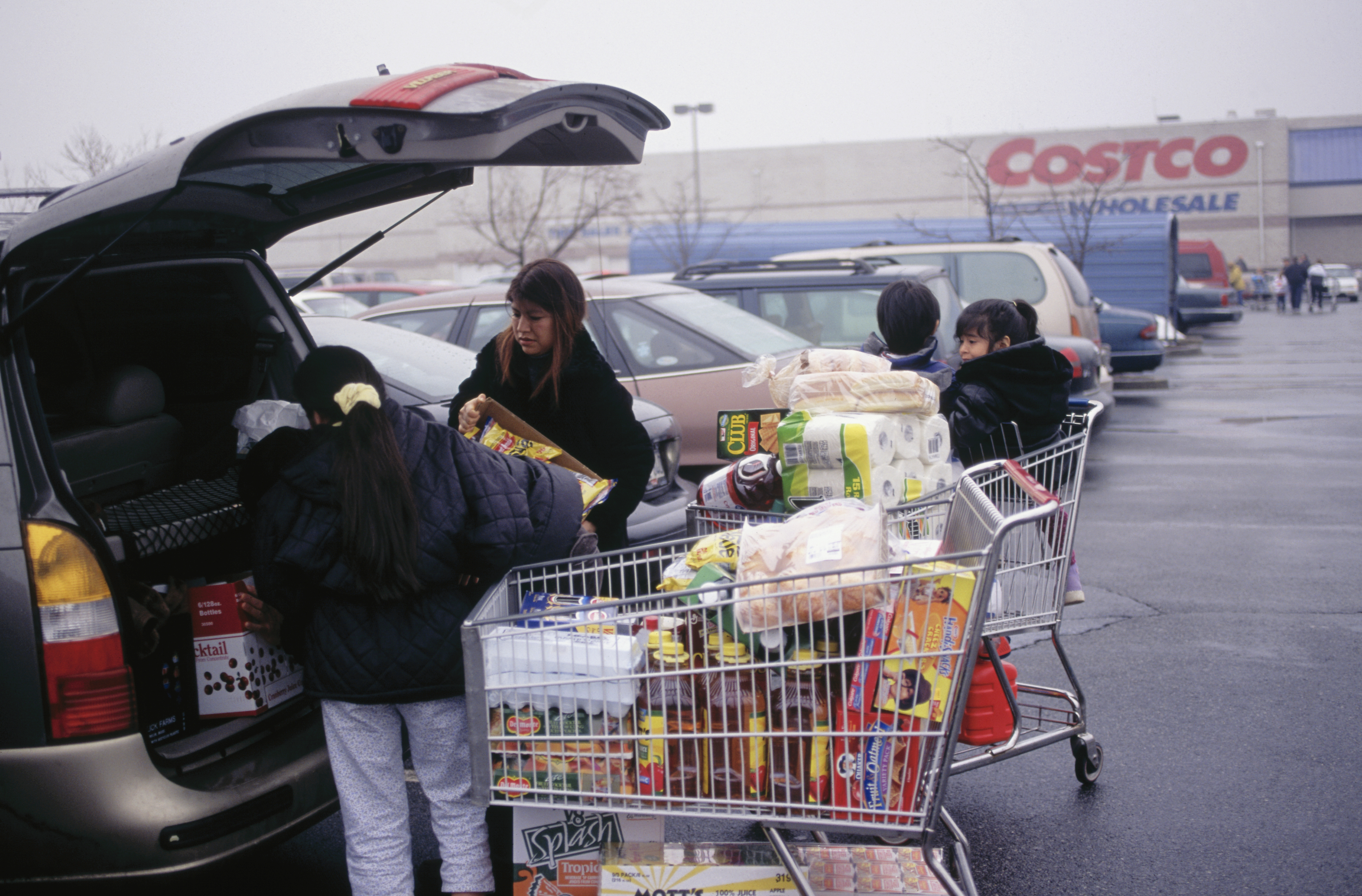 Family Loading Their Purchases in Car at Costco Store