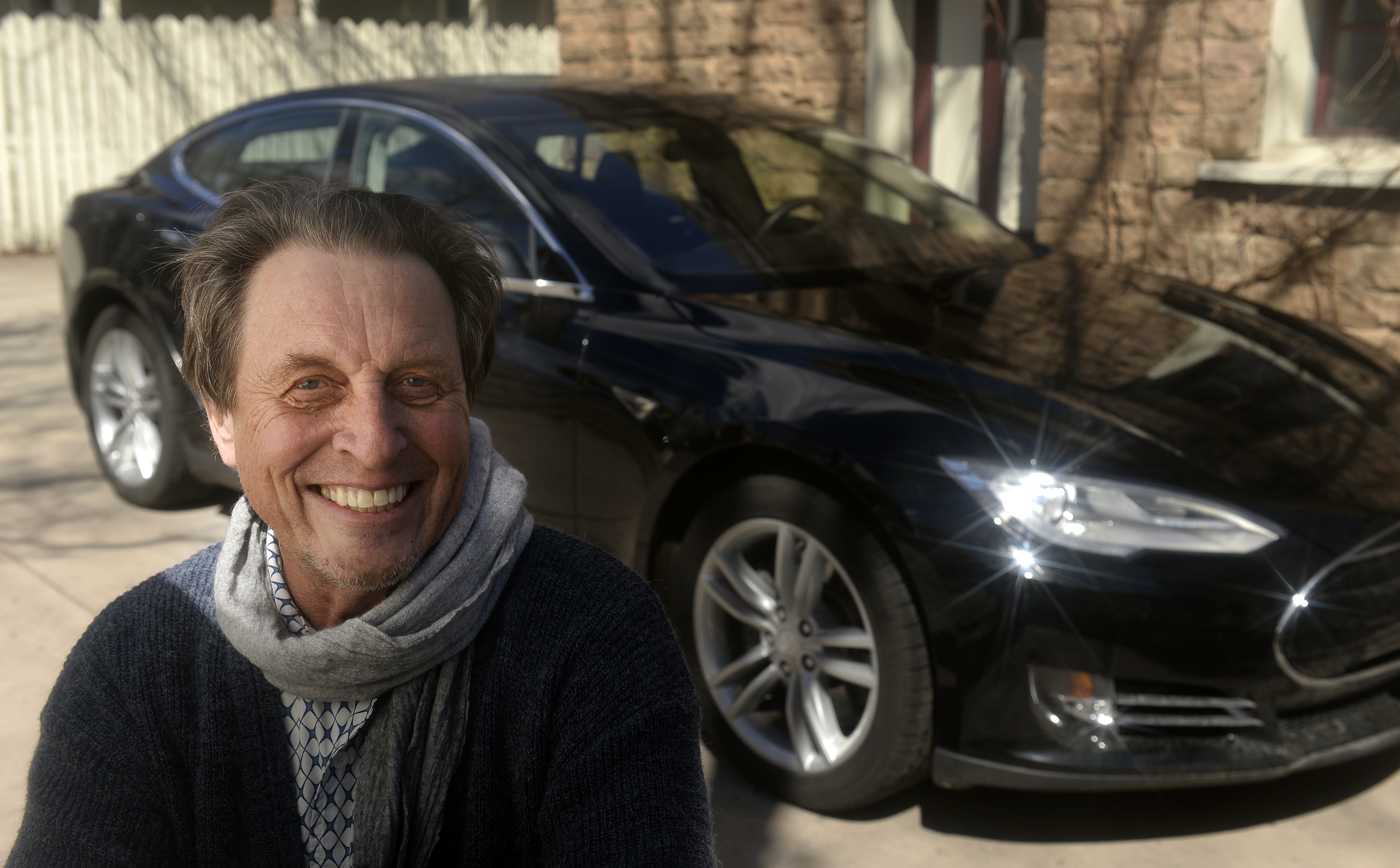 South African Errol Musk who the father of billionaire entrepreneur Elon Musk. In the background is a Tesla Model S.