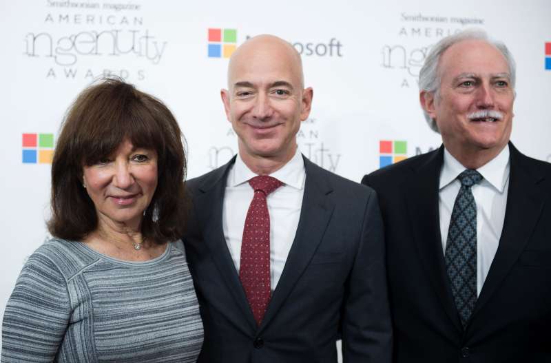 Jeff Bezos and his parents smile on the red carpet for an event
