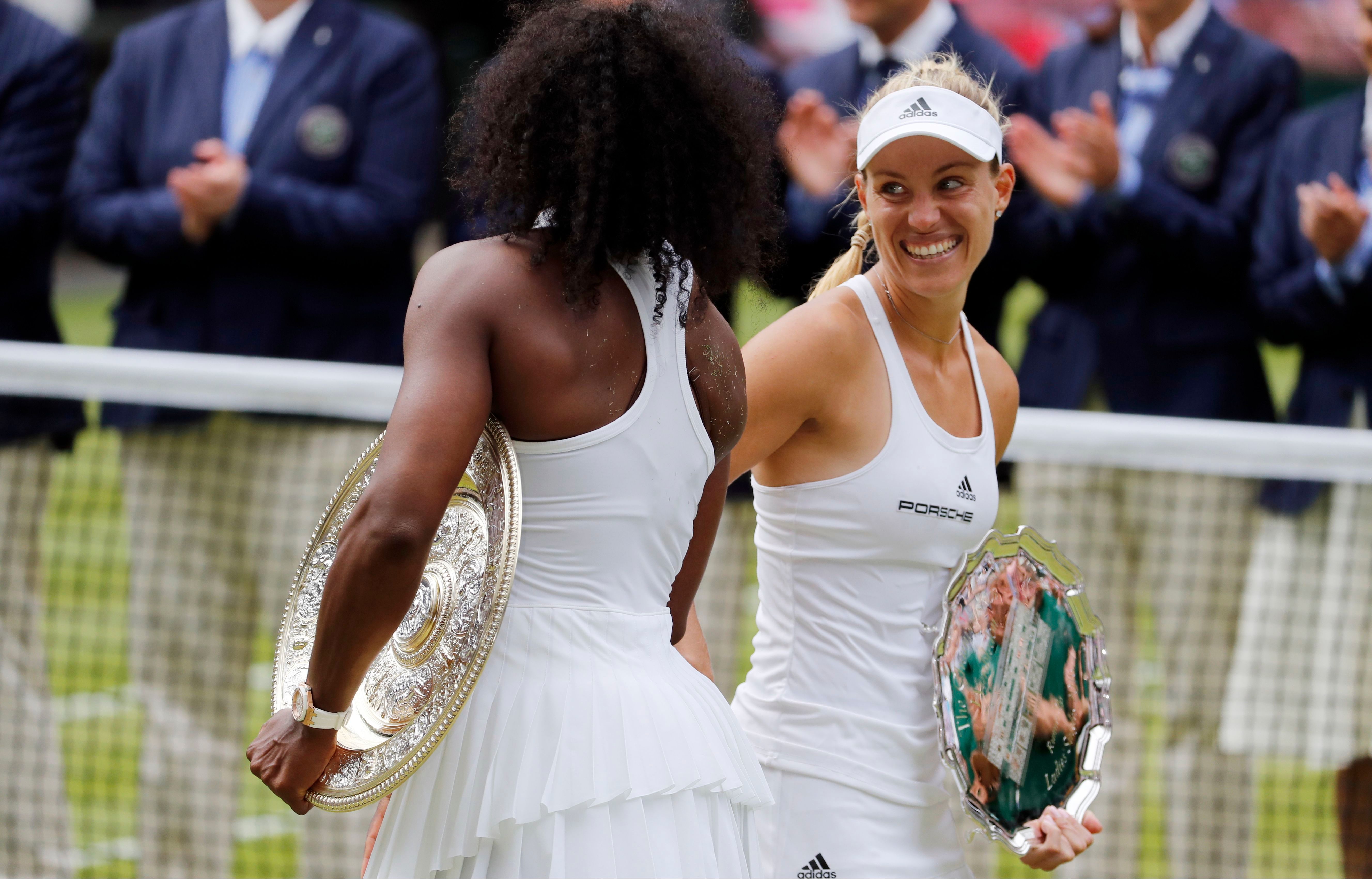 Serena Williams and Angelique Kerber, both wearing white, shake hands.