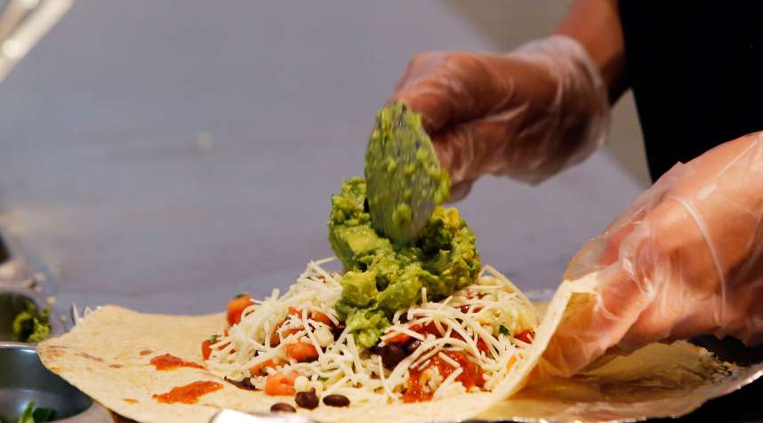 An employee prepares a Chipotle Mexican Grill burrito at the Sunset and Vine store in Hollywood, Calif.