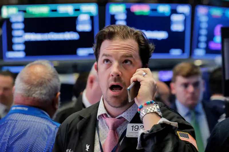 Traders work on the floor of the NYSE in New York