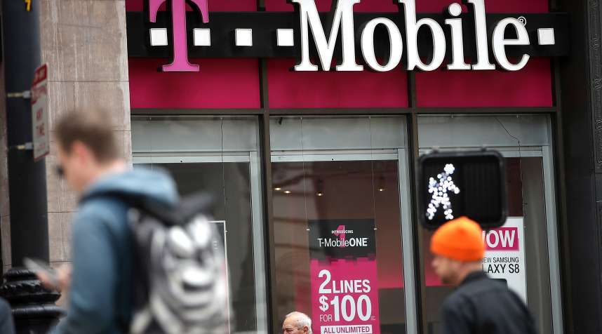 Pedestrians walk by a T-Mobile store on April 24, 2017 in San Francisco, California.