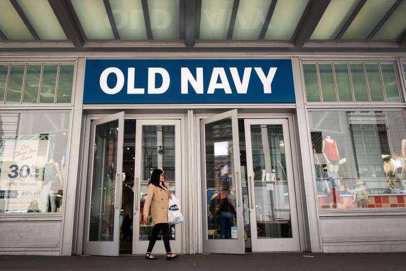 A woman carries her shopping bag as she exits an Old Navy store, May 12, 2017 in the Herald Square neighborhood in New York City.