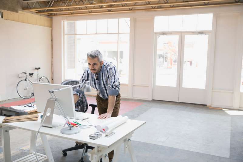 Businessman working at computer in new office