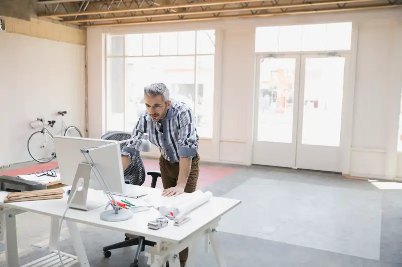 Businessman working at computer in new office