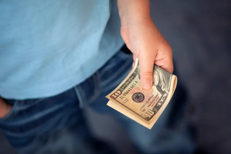 Young boy holds money