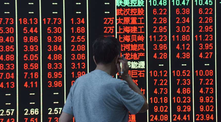An investor observes the stock market at a stock exchange hall on July 12, 2018 in Hangzhou, Zhejiang Province of China.