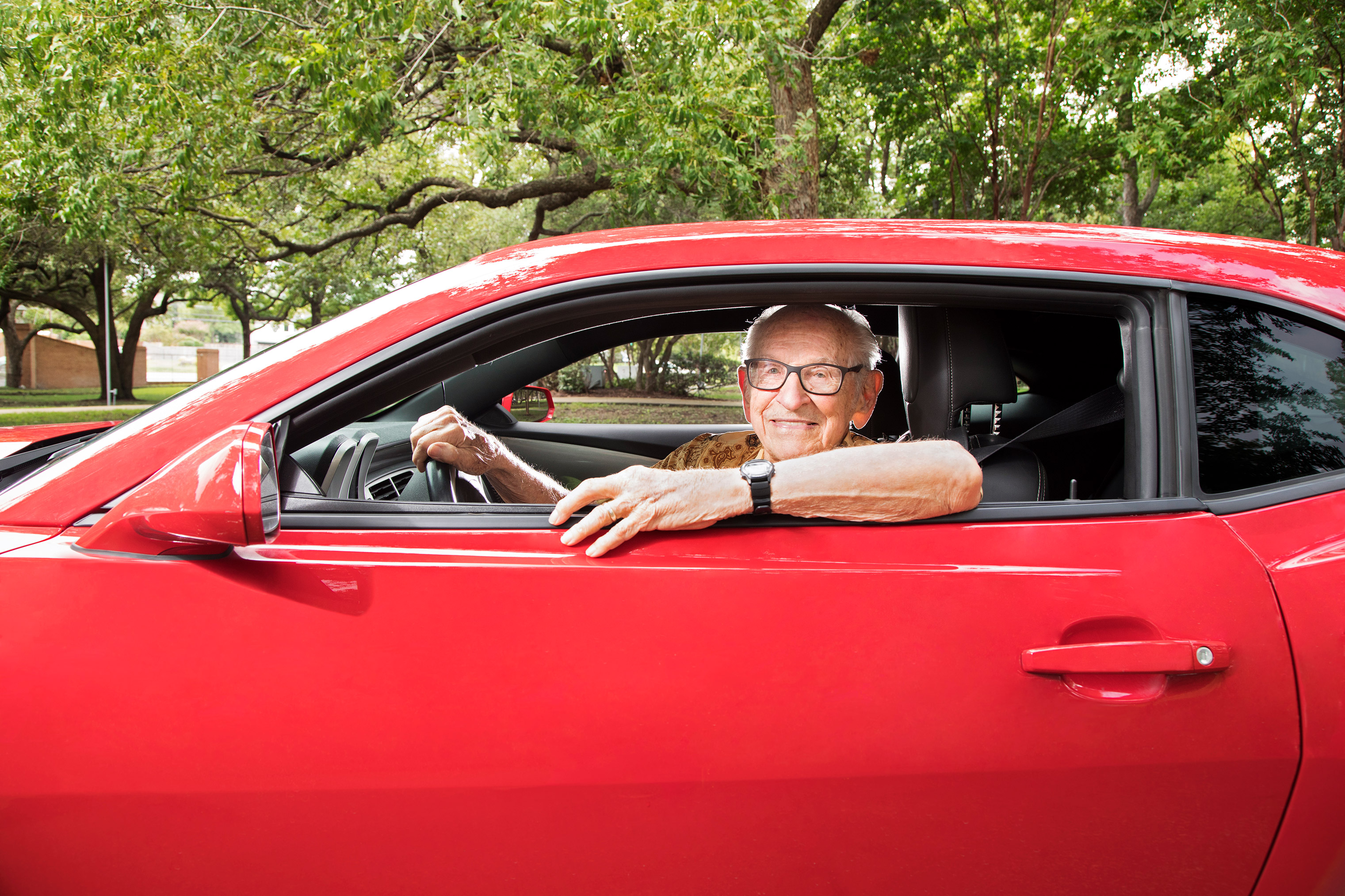 Orville Rogers, age 100, in his cherished 2013 Chevy Camaro, is still cruising after 40 years of retirement.
