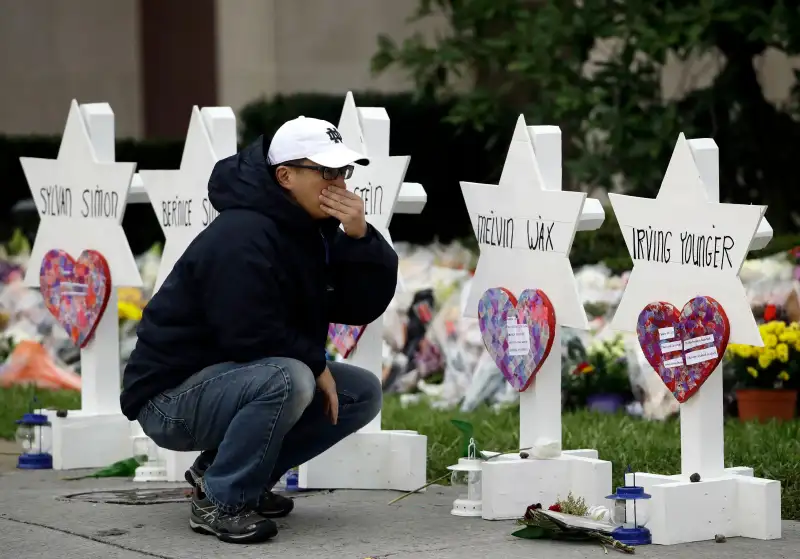 A person pauses in front of Stars of David with the names of those killed in a deadly shooting at the Tree of Life Synagogue, in Pittsburgh, October 29, 2018.