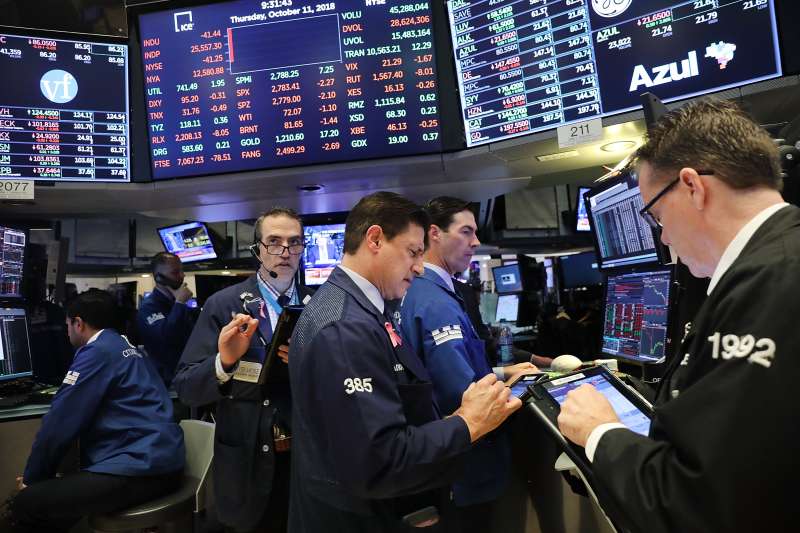 Traders work on the floor of the New York Stock Exchange (NYSE) on the morning of October 11, 2018.