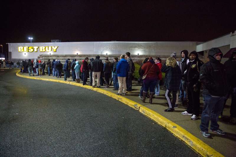 The line outside of Best Buy wraps all the way around the building at the Maine Mall just before midnight on Thanksgiving.