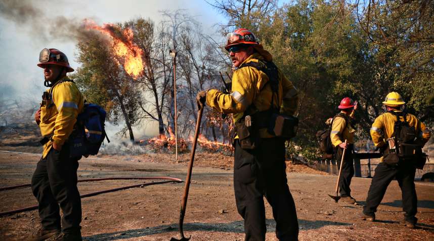 Firefighters battle a blaze at the Salvation Army Camp on November 10, 2018 in Malibu, California.