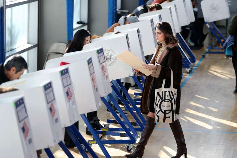 A voter walks to a booth to fill in her ballot at a polling station in Brooklyn, New York, the United States, on Nov. 8, 2016.