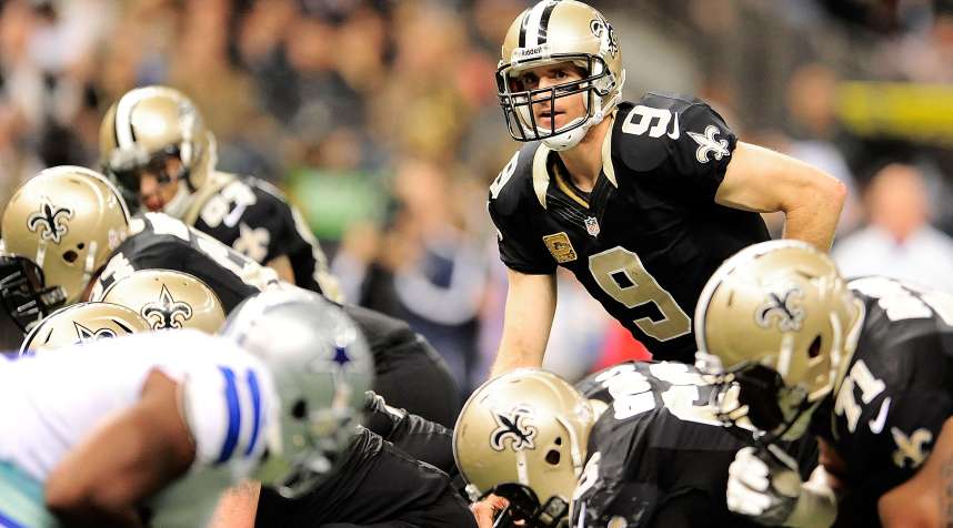 Drew Brees of the New Orleans Saints calls a play during a game against the Dallas Cowboys in 2013.