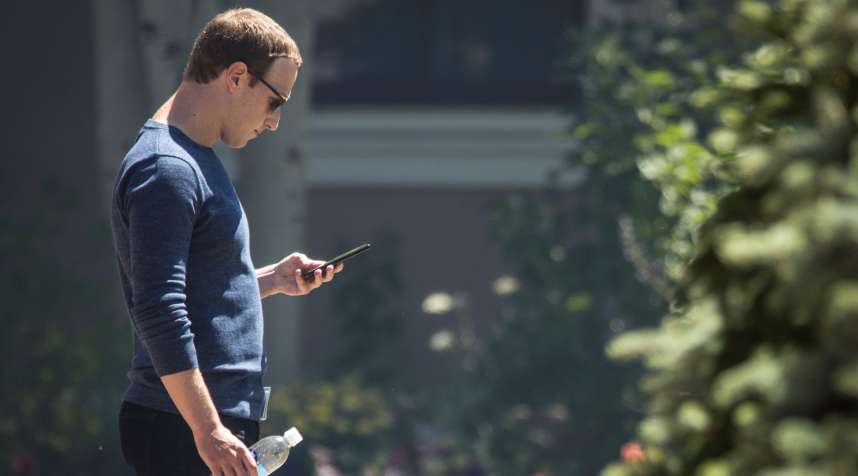 Mark Zuckerberg, chief executive officer of Facebook, checks his phone during the annual Allen and Co. meeting In Sun Valley, Idaho, July 13, 2018.