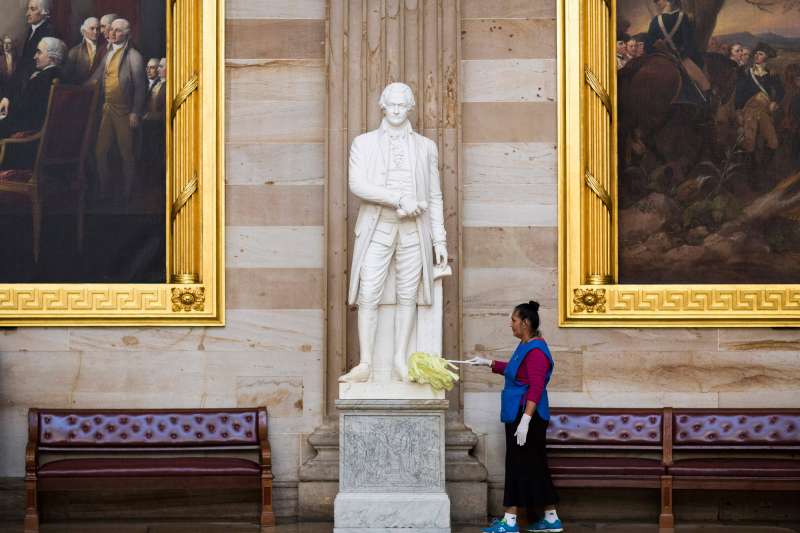 Maria Bernal de Navarrette cleans a statue of Alexander Hamilton, a Founding Father of the United States, in Rotunda on Capitol Hill in Washington October 15, 2013.
