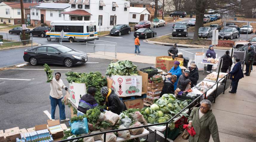 Volunteers and church members of First Baptist Church of Capital Heights help organize hand out food to people, Maryland  on December, 27, 2016. This church is a drop off location for  The Capital Area Food Bank.