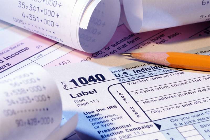 Tax forms, pencil and receipts, close-up