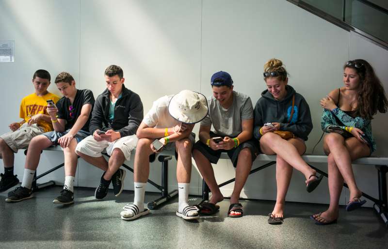 Teens Look At Their iPhones At The Rock And Roll Hall Of Fame